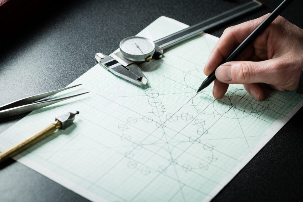 Jewelry,Designer,Works,On,A,Hand,Drawing,Sketch,Of,The
